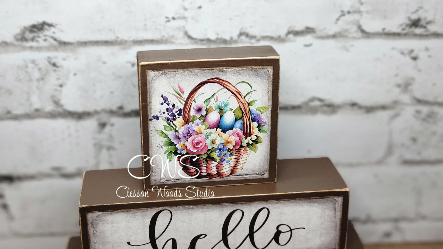 Hello Spring Basket of Flowers and Colored Eggs Brown Wood Block Stack