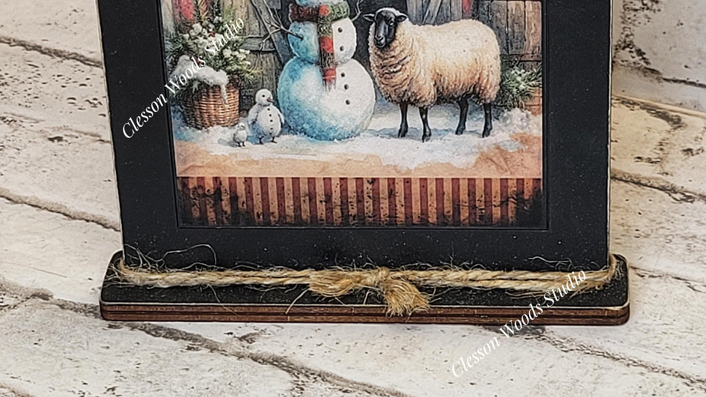 Primitive Winter Barn Snowman and Sheep Framed Art with Attached Stand