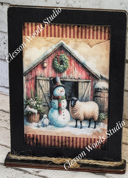 Primitive Winter Barn Snowman and Sheep Framed Art with Attached Stand